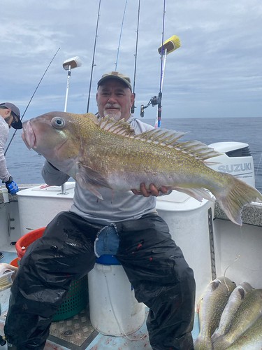 Man sitting on a boat with a fish