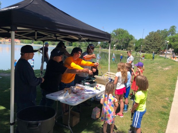 Kids learn to fish at a recent City Park fishing clinic on Ferril Lake, where free poles and other equipment were available for use. (Provided by Denver Parks & Recreation)