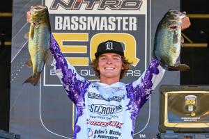 Grant Neubauer holding two bass at a Bassmaster Elite Qualifier weigh-in